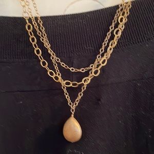 Brushed gold necklace.